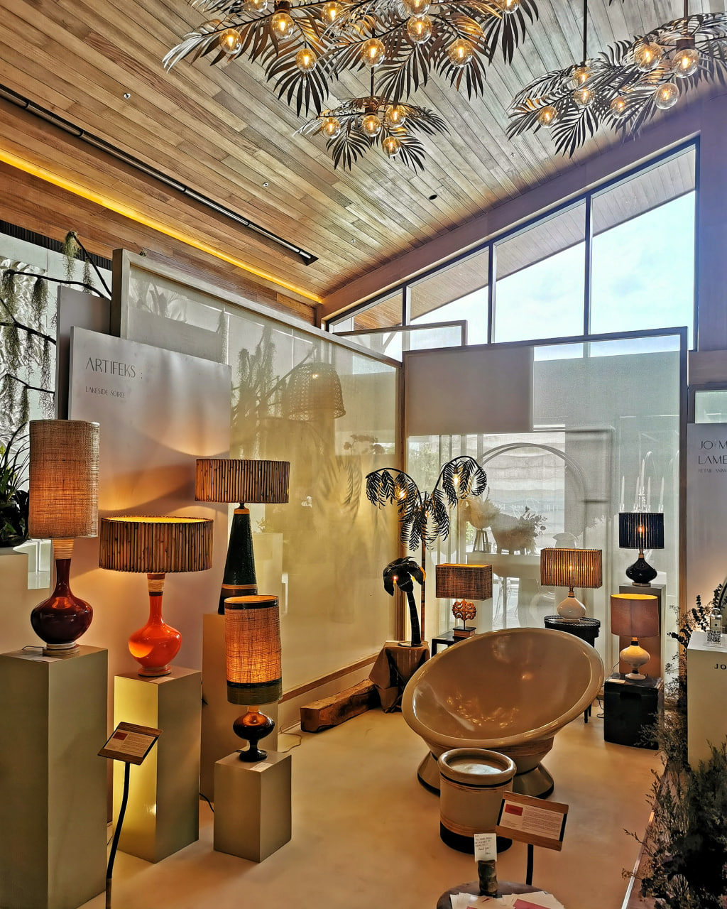 "Dekada Cinquenta" lamps - made in local plant material like abaca, runo and jute; center piece is a Papasan sans cushion and footstool