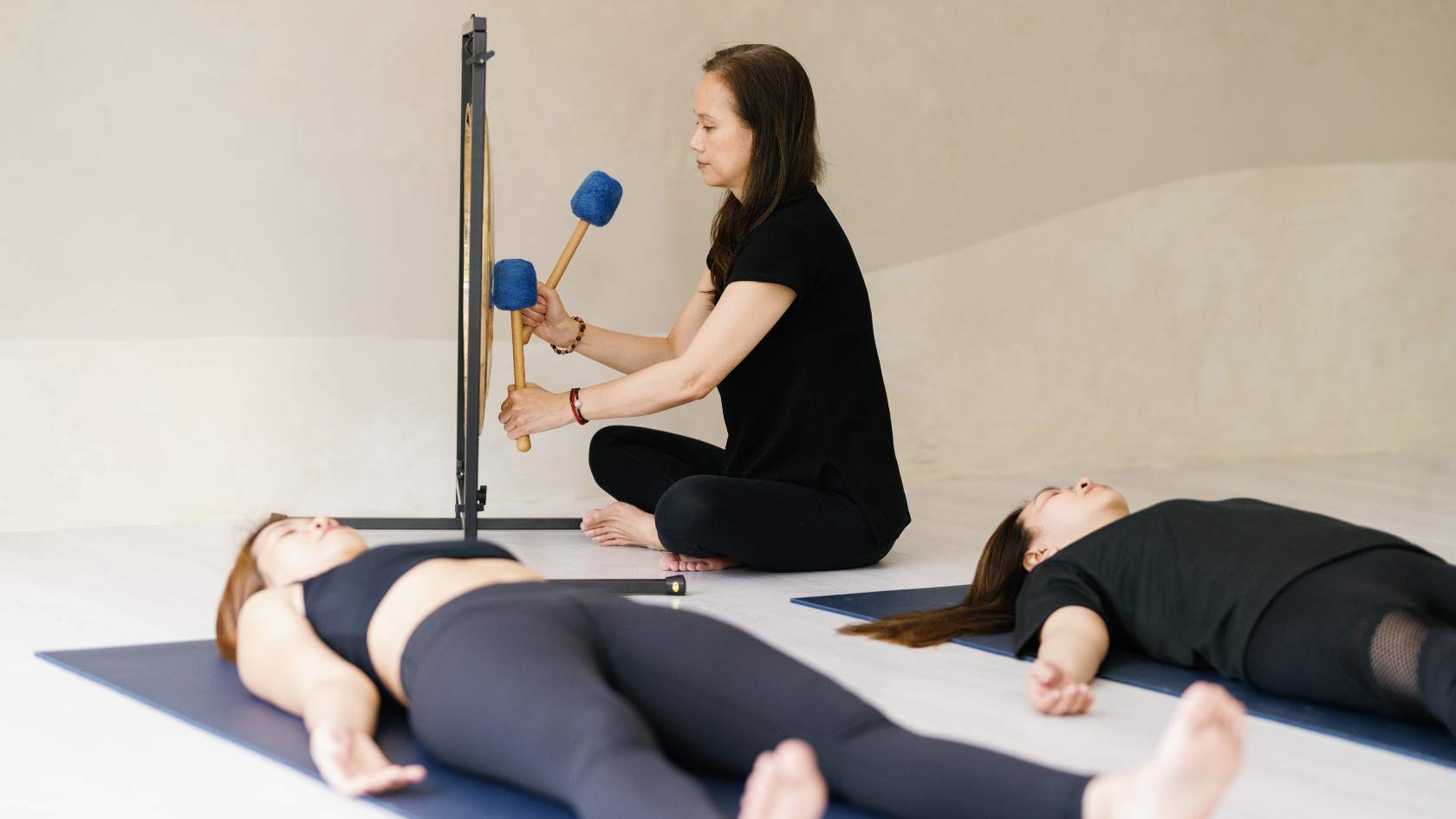 Tet uses the gong to make her clients feel grounded and centered