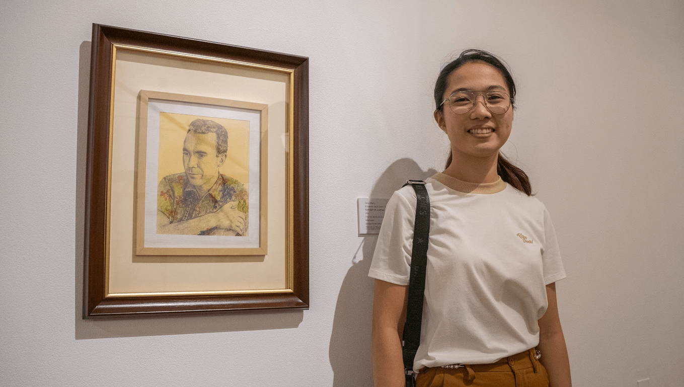 Glecy Alberto beside her donation portrait of Sansó
