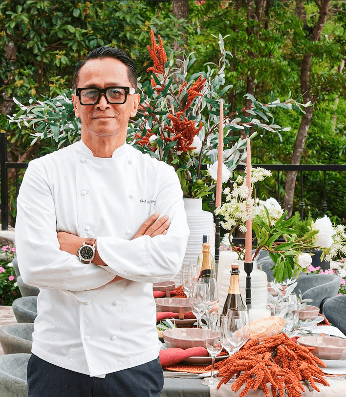 Chef Sau beside an al fresco table set up for special occasions