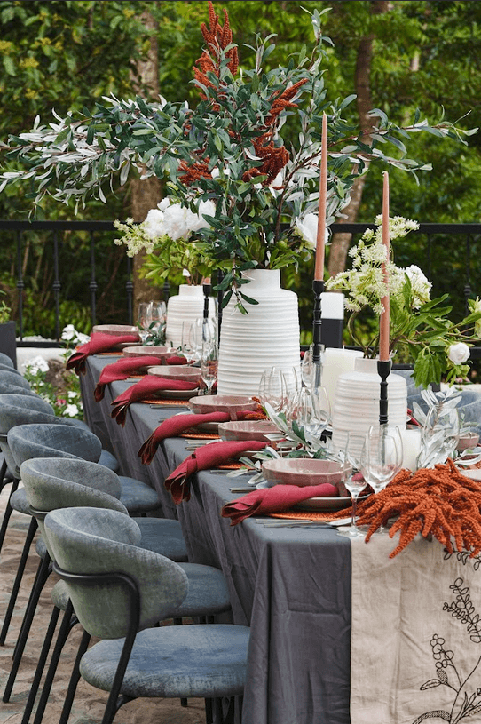 Chef Sau beside an al fresco table set up for special occasions