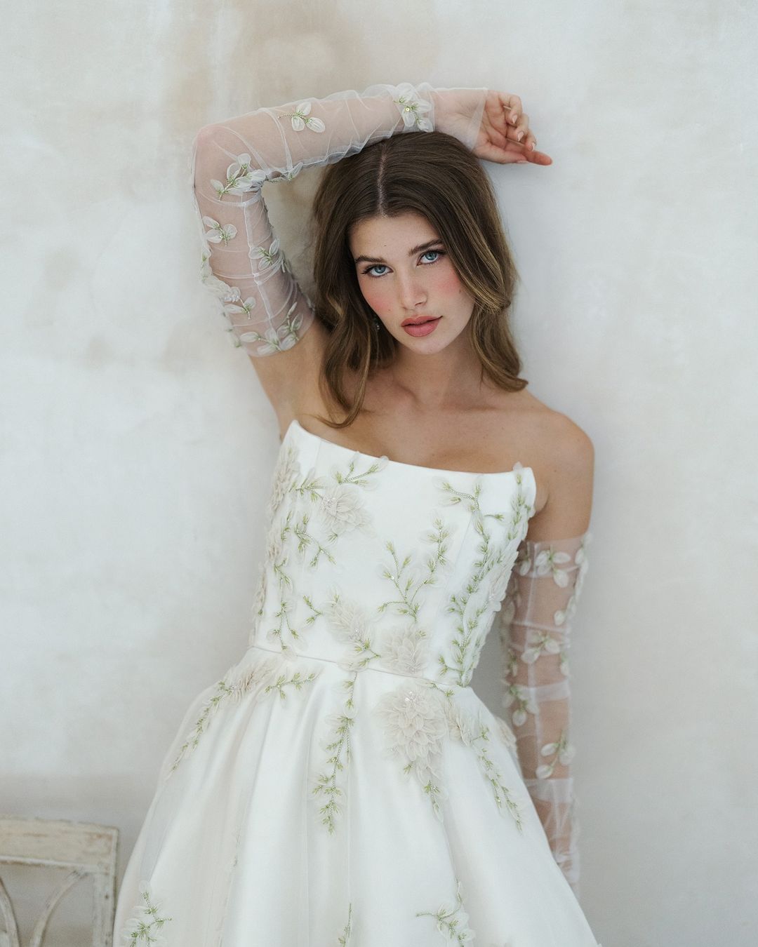 A duchess satin gown with organza embroidery and fingerless gloves