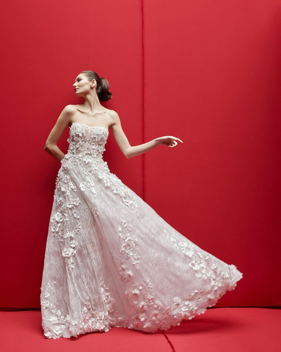 This gown has laces, silk flowers, and pearls