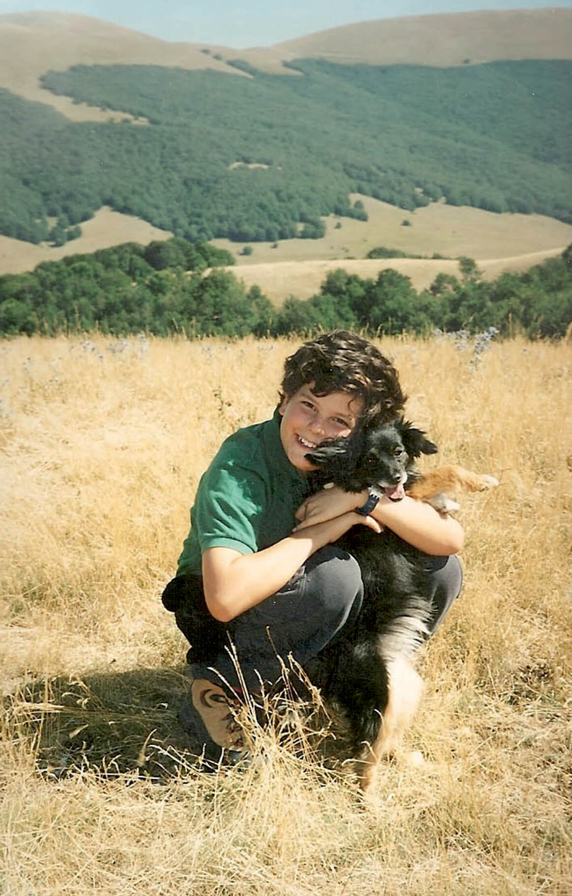 A young Carlo Acutis with his dog