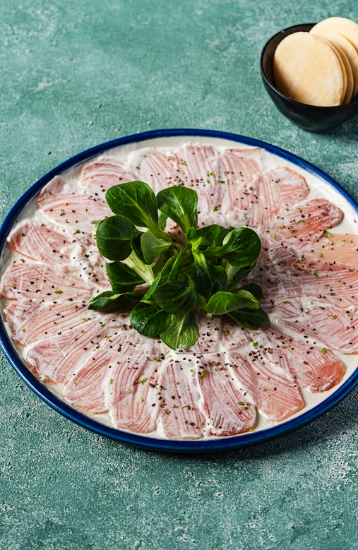 TOP (L-R): Beef Tomahawk; Slow Cooked Truffle Honey Iberico Pork Ribs. LEFT (L-R): Yellowfin Tuna Carpaccio; Parmesan Cheese and Bacon Croquetas.