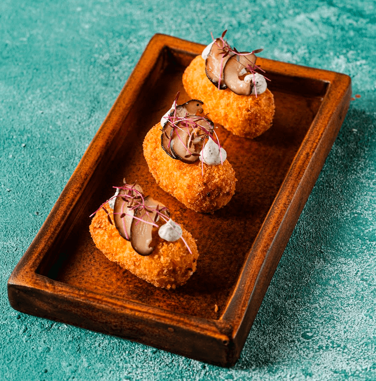 TOP (L-R): Beef Tomahawk; Slow Cooked Truffle Honey Iberico Pork Ribs. LEFT (L-R): Yellowfin Tuna Carpaccio; Parmesan Cheese and Bacon Croquetas.