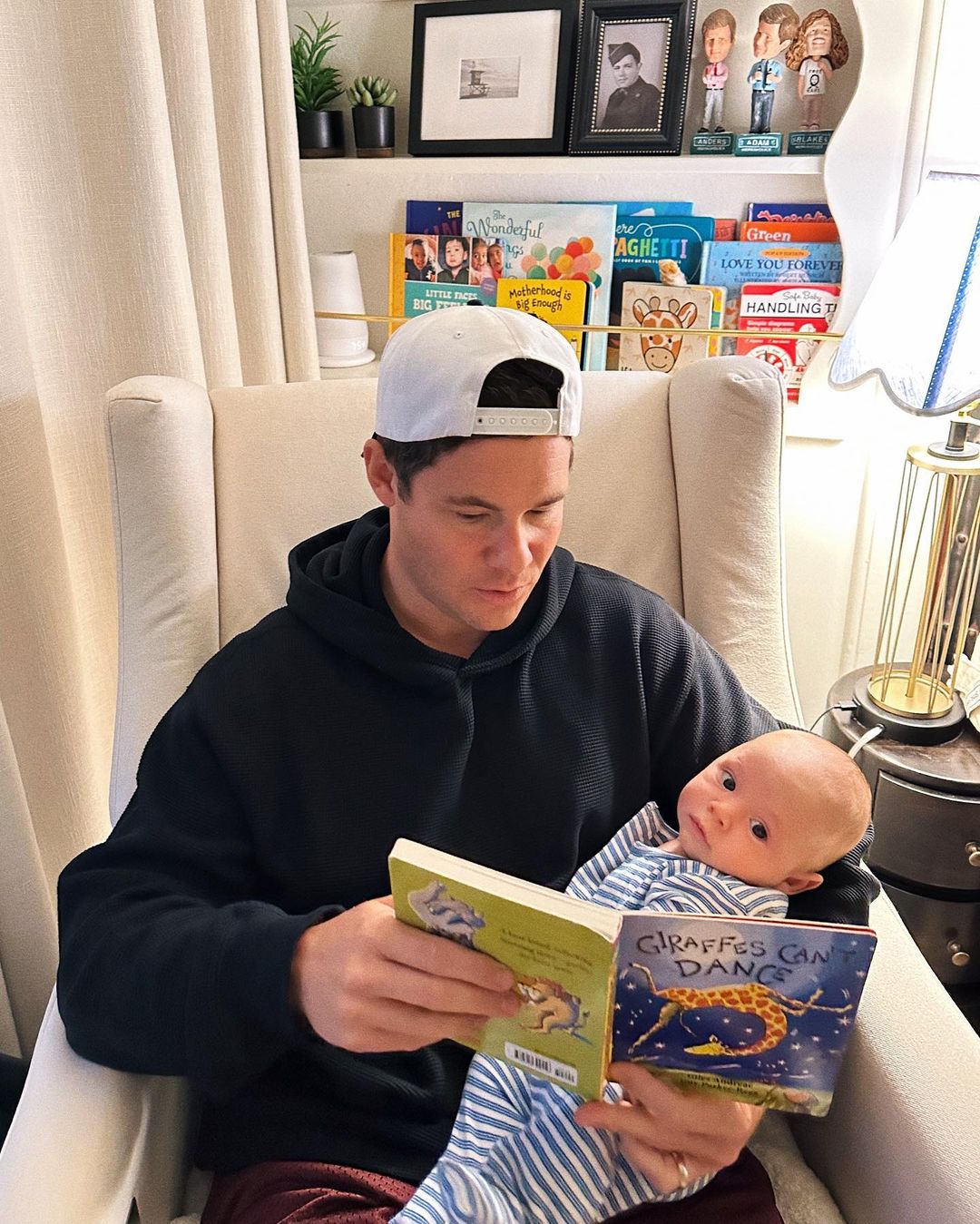 The proud dad bonds with Beau through books