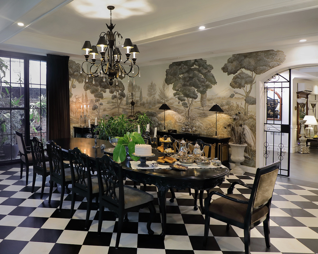 LEFT: The Gloria Macapagal-Arroyo Room at Laperal Mansion, Arlegui Guest House. RIGHT: A traditional-style dining room featuring a hand-painted wall by Tara Soriano that provides an idyllic backdrop for the vintage and custom made furniture.