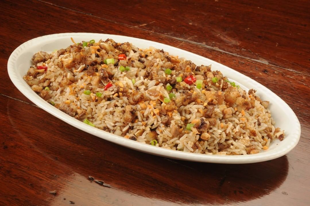 TOP LEFT: Bistek Tagalog ng Kano. TOP RIGHT: Crispy Patang Bawang. BOTTOM LEFT: Tilapia with Sweet Plum Sauce. BOTTOM RIGHT: Sisig Fried Rice.