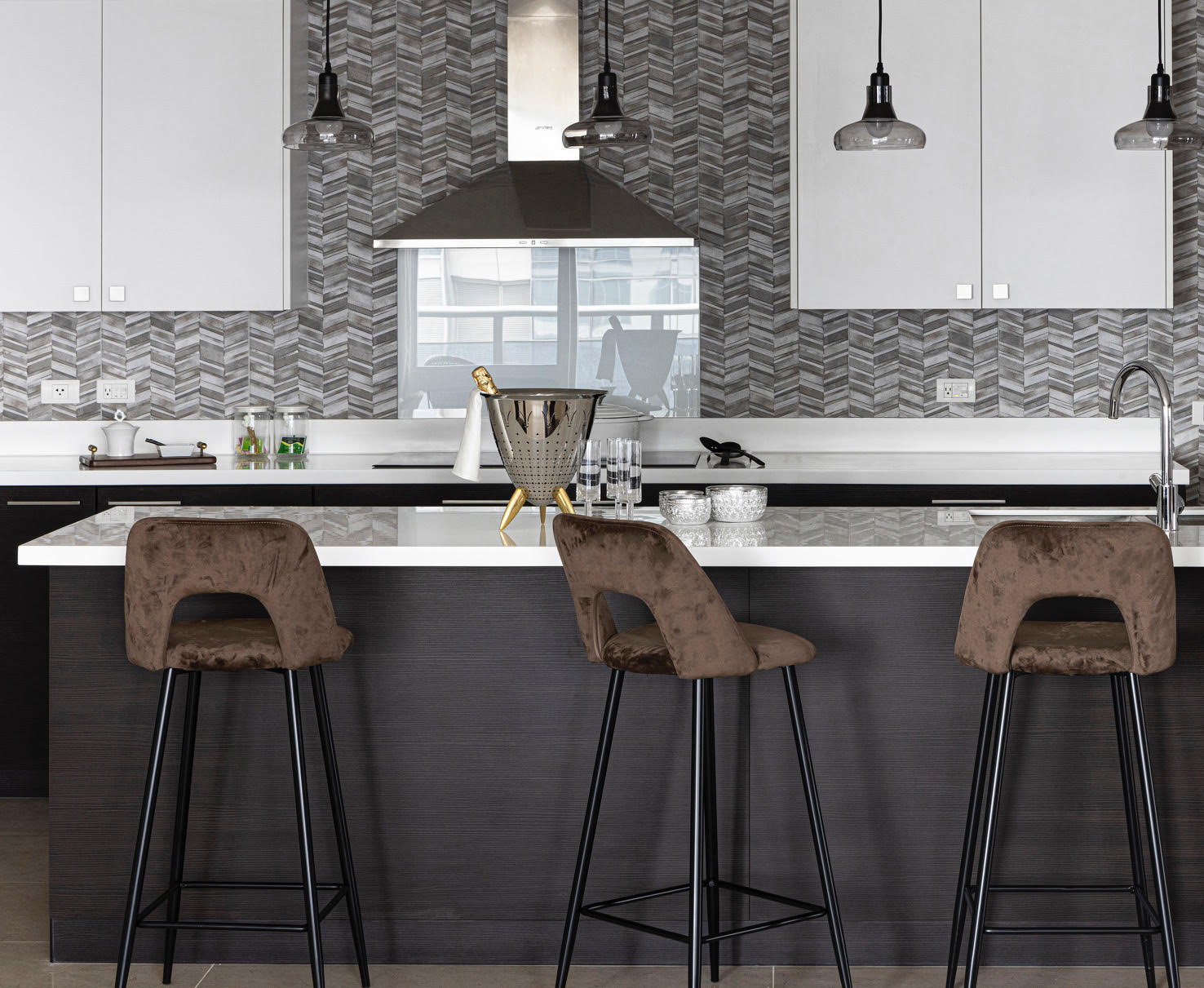 LEFT: From concept to design implementation, applying a masterful mix of materials is key to create an ambiance that evokes a comfortable and moody environment/Photo by Arthur Tselishchev. RIGHT: A textured wall complements the modular cabinetry in this contemporary style kitchen/Photo by Jar Concengco.