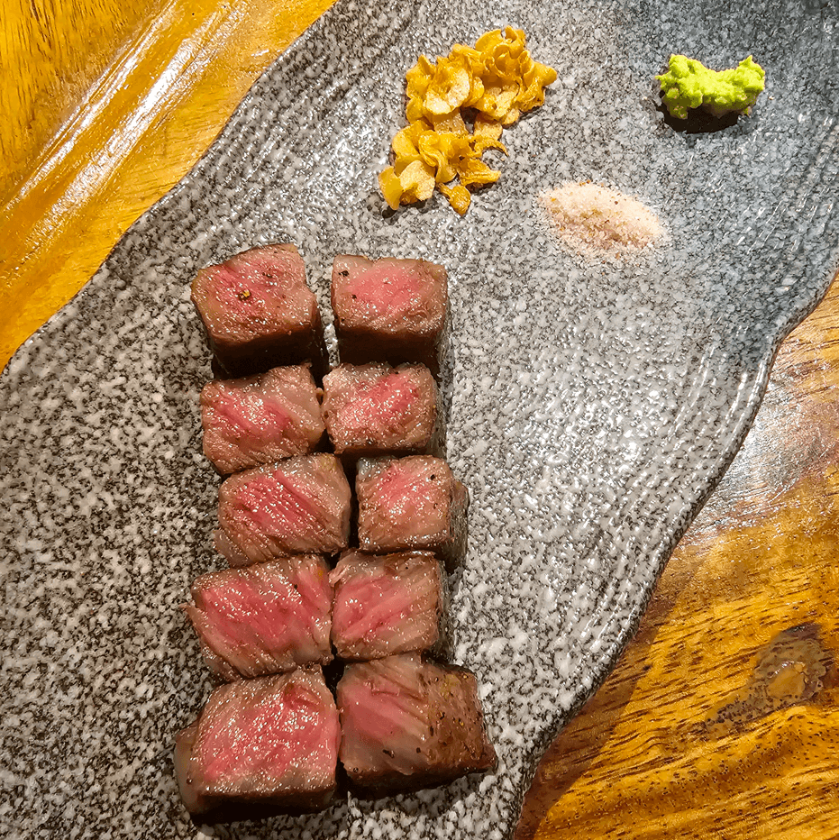 L-R, top to bottom: Japanese A5 Kagoshima Wagyu Sirloin with Fresh Wasabi and Garlic Chips; Norwegian Salmon Belly with Sautéed Avocado Seaweed and Fresh Wasabi Sauce; Lobster Sautéed with White Miso Vin Blanc Sauce with Local Vegetables; A5 Kagoshima Wagyu.