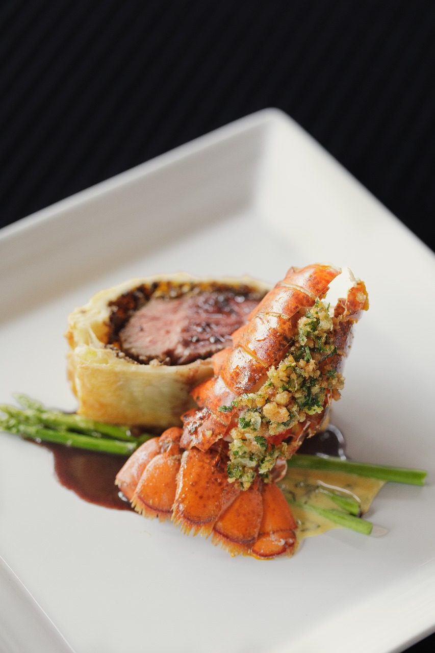 TOP LEFT: USDA Beef Wellington and Lobster Tail. TOP RIGHT: Mango Panna Cotta. BOTTOM LEFT: Poached Salmon with Potato Puree and Asparagus. BOTTOM RIGHT: Corn Chowder with Lavash.