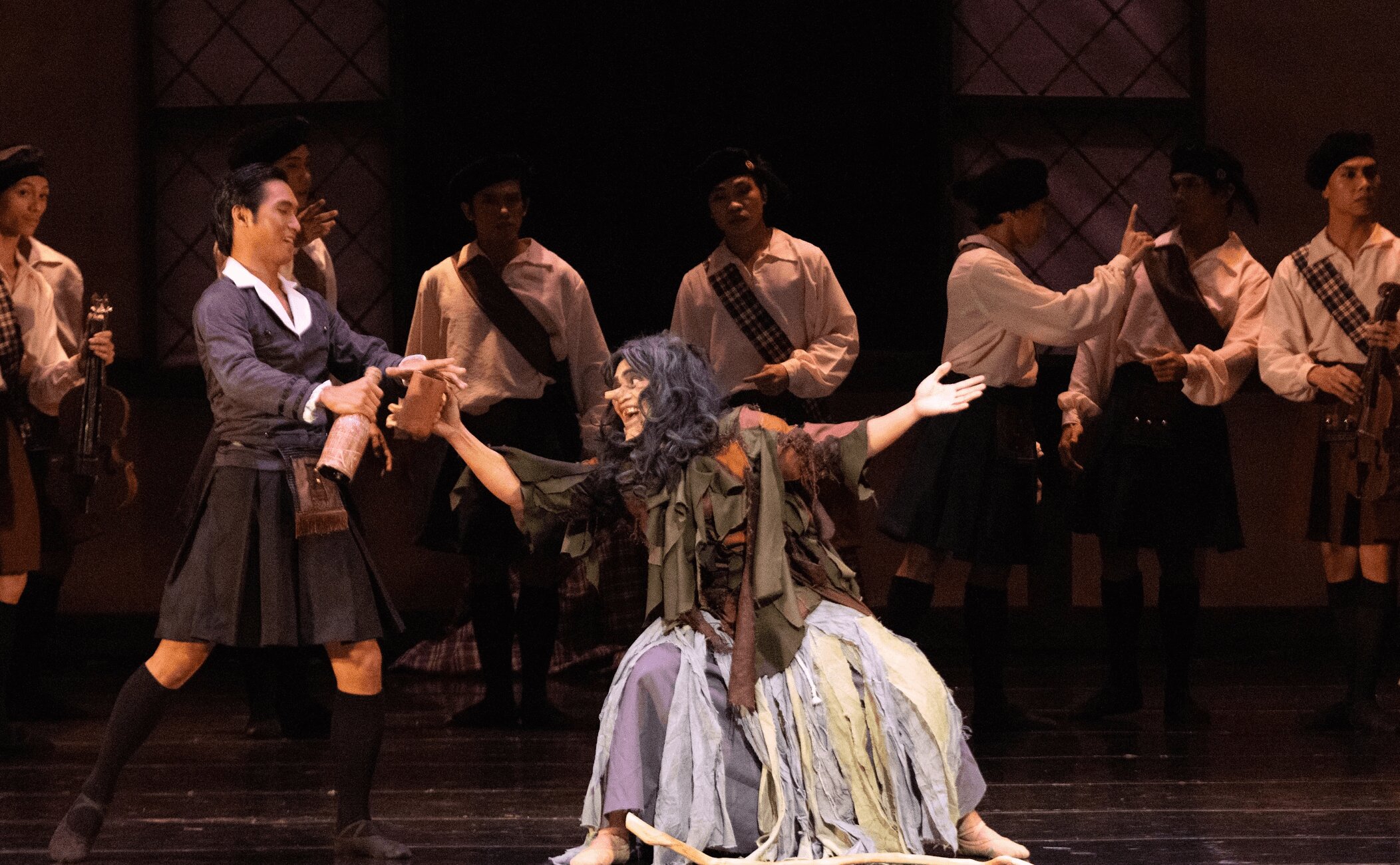 This image has an empty alt attribute; its file name is Screenshot-2024-08-19-at-12.02.11%E2%80%AFPM.jpg
Madge the witch (right), player by Peter San Juan, along with James' friend Gurn (left), played by Mark Balucay