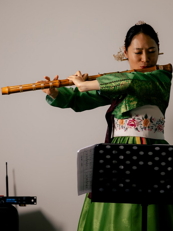 LEFT: Daegeum (Korean flute) player, Kim Hyelim. RIGHT: Percussionist Kim Hannah.