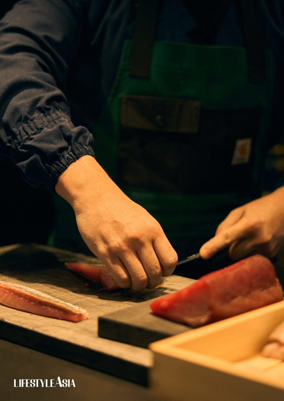Chef Bruce slicing tuna, and a live king crab