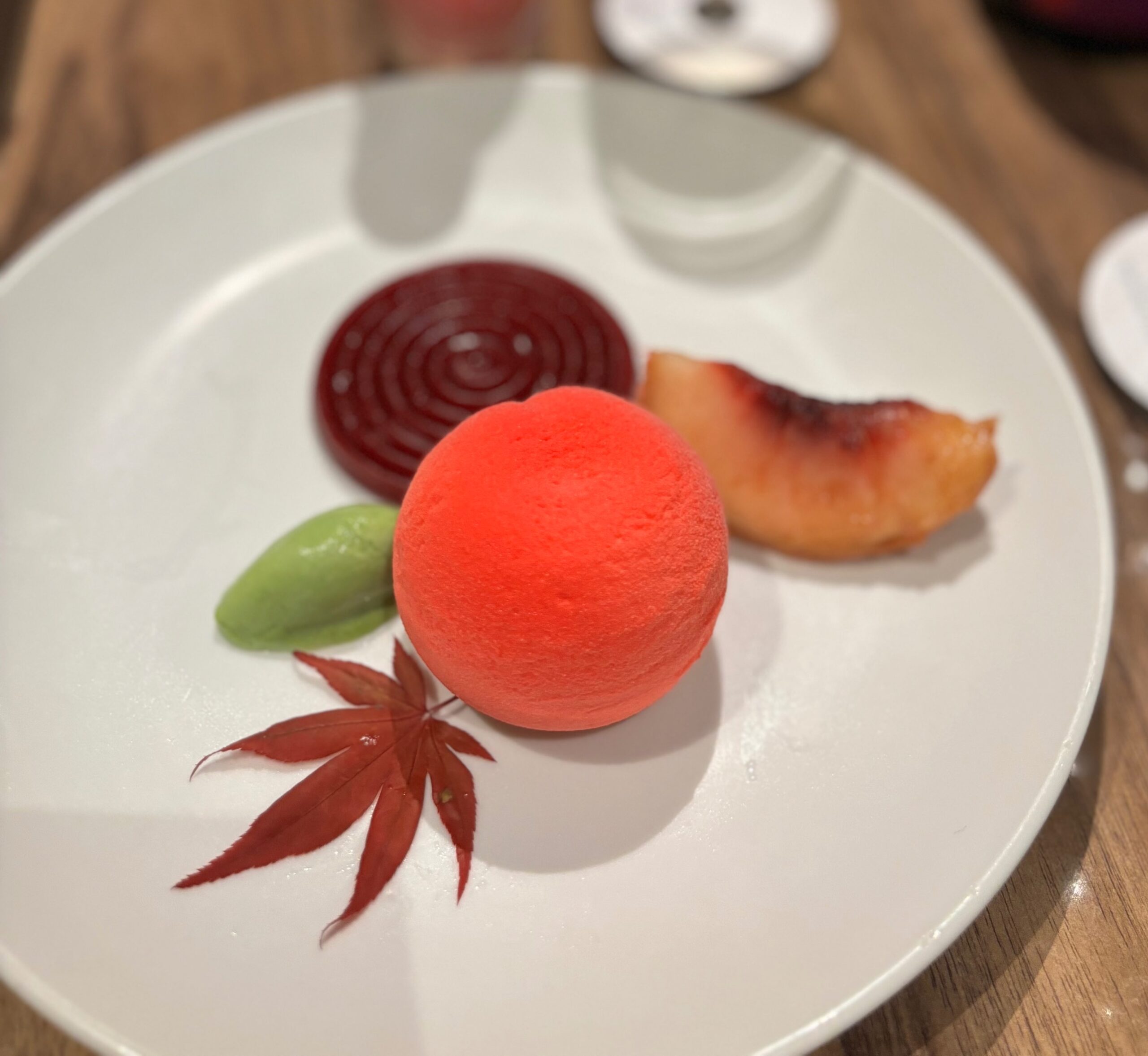 Matcha Ice Cream with peach sake sauce, jelly, and toasted flaxseed biscuit