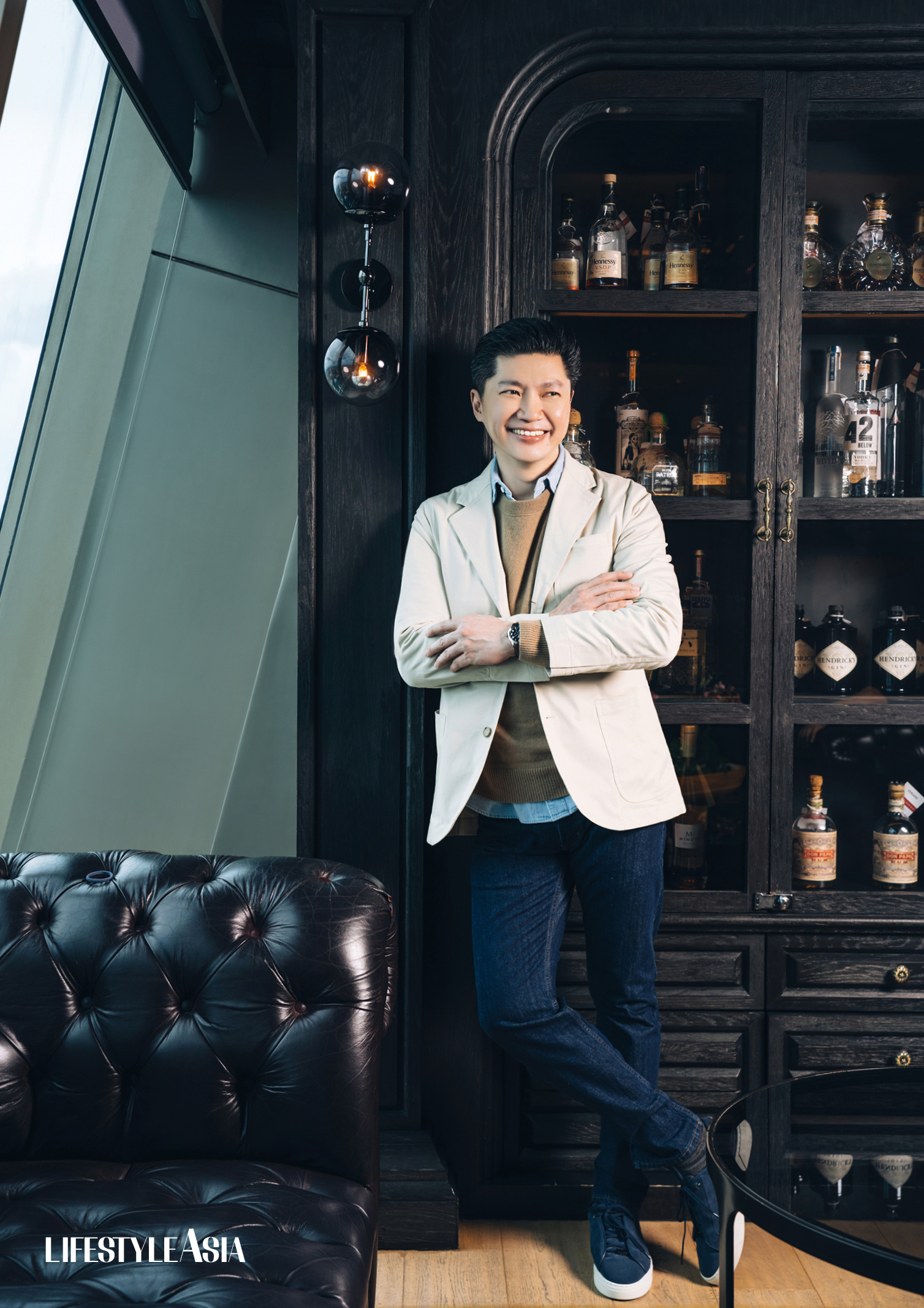 Leading dentist Dr. Steve Mark Gan (Jacket, sweater, and shirt from BANANA REPUBLIC; jeans from MARKS & SPENCER)