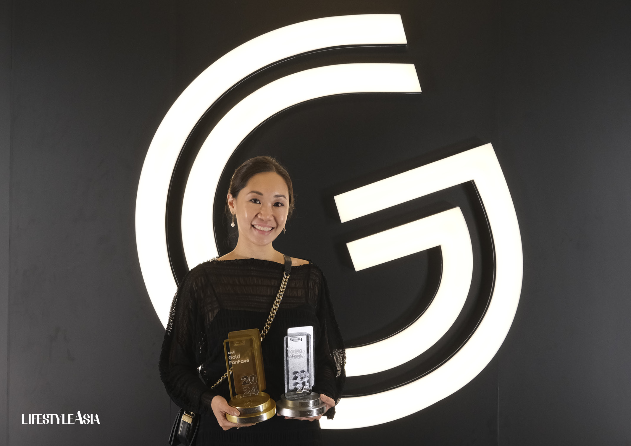 CloudEats CEO and co-founder Kimberly Yao proudly holding some of the brand's Golden Grab Awards 2024 trophies