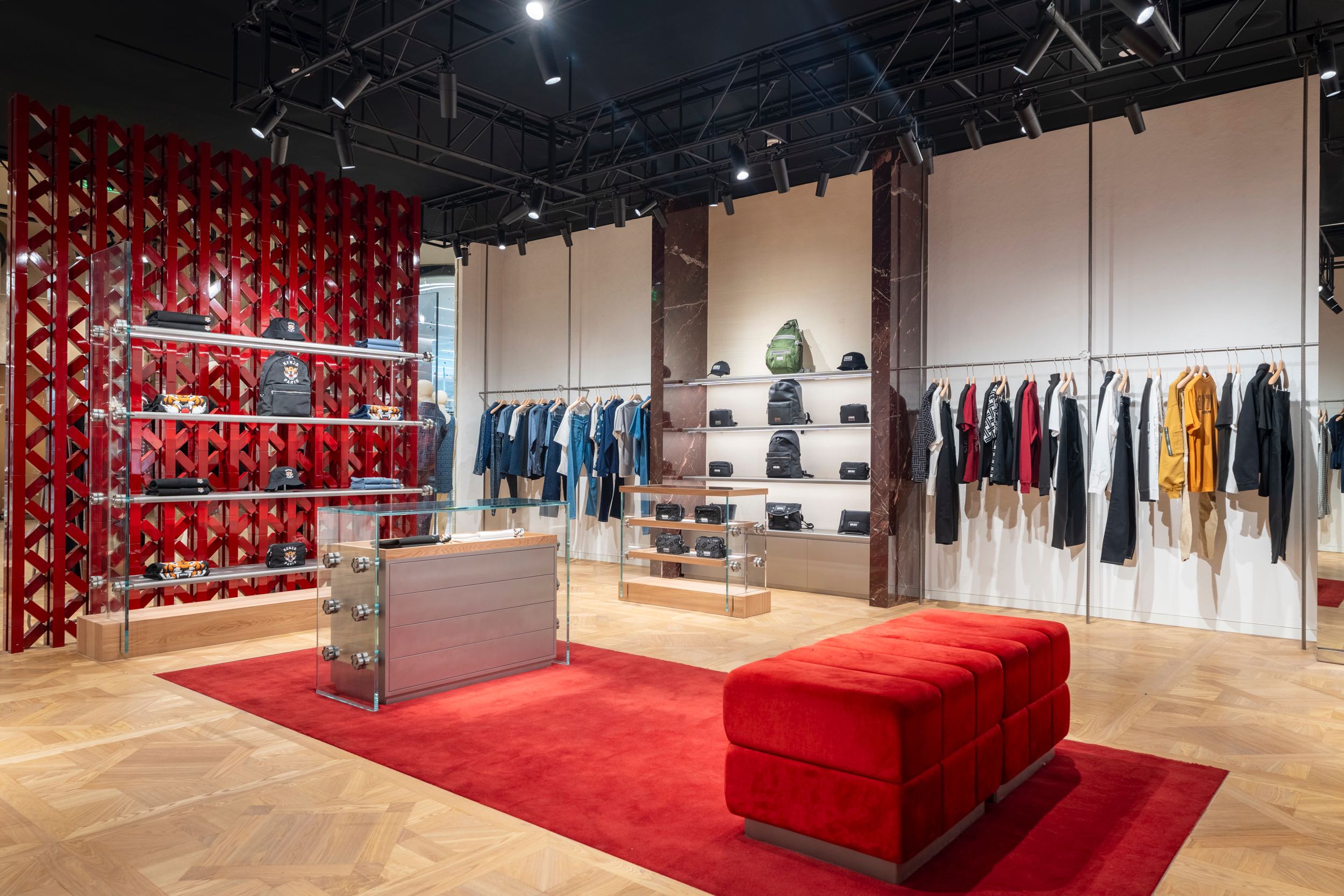 Kenzo’s 155 square meter store presents a youthful and immersive retail experience, complete with anodized aluminum hanging structures, red school locker-inspired shelves, and the signature Boke flower accents, capturing the energetic spirit of the brand under the direction of NIGO
