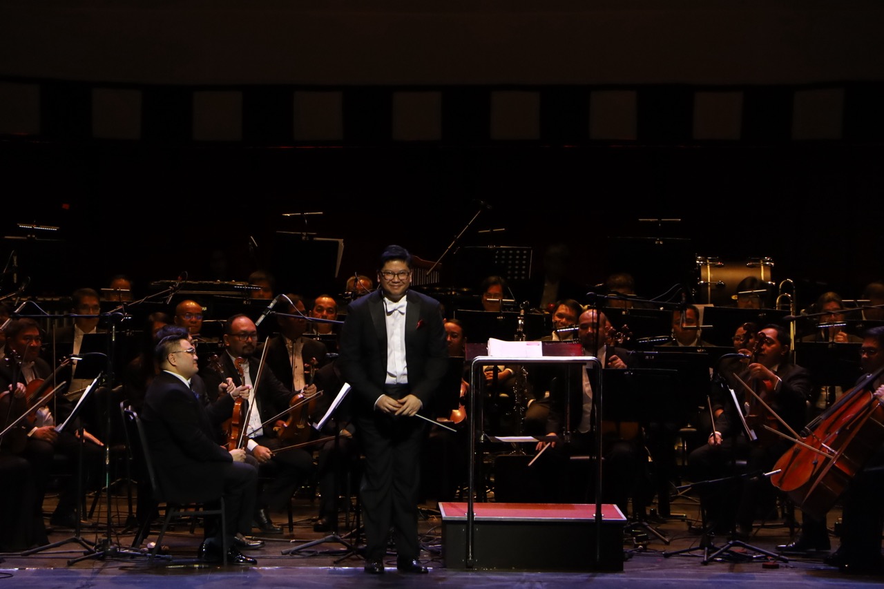Conductor Gerard Salonga with the orchestra