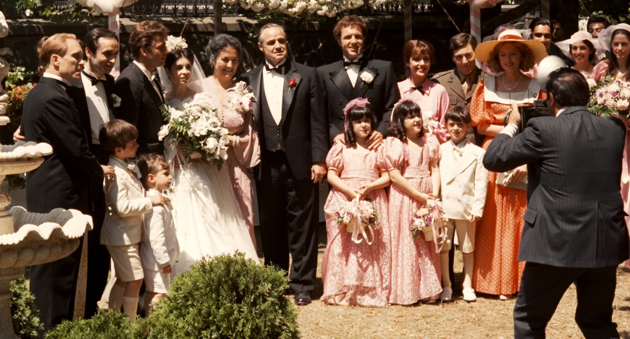 The fictional Corleone family poses for a group photo in the opening sequence of "The Godfather" 