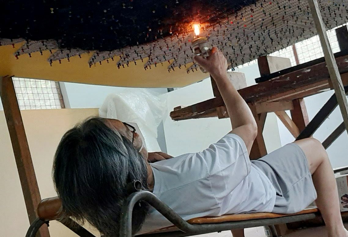 Junyee working on one of his soot creations