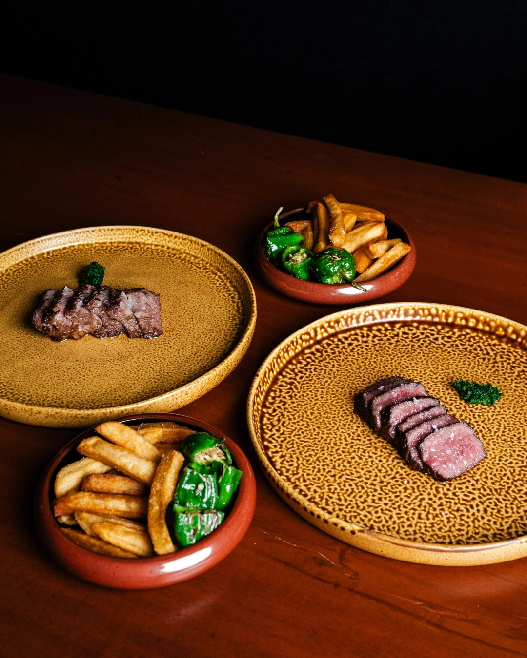 Among the choices for the main course are short ribs and Zabuton wagyu, both served with homemade fries and a plate of sweet piquillo peppers