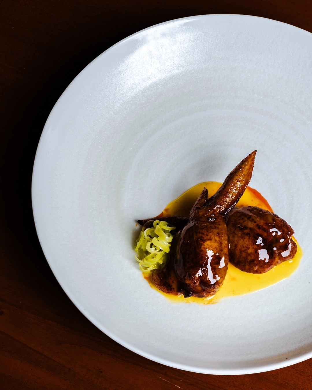 Tebasaki chicken wing is stuffed with molejas and veal sausage