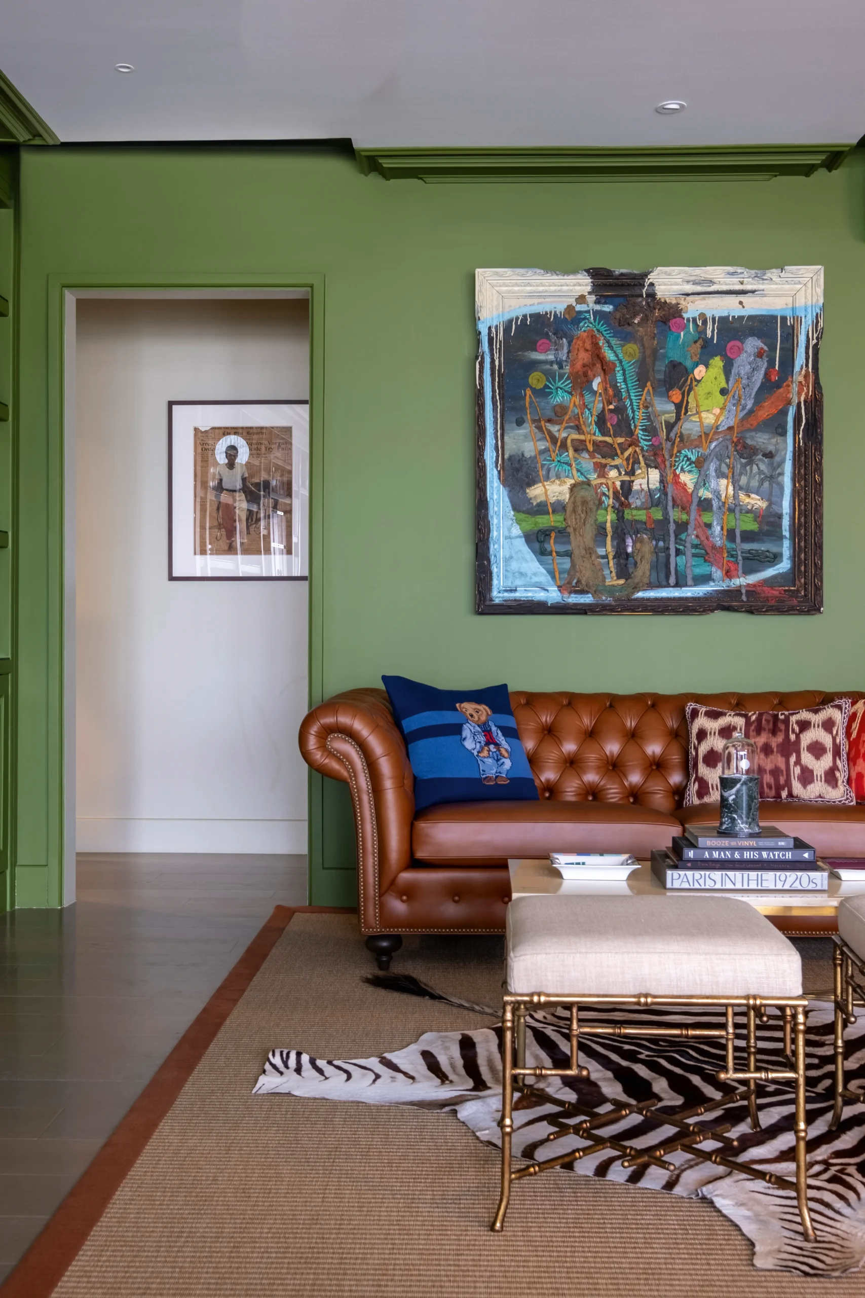 The living area features artwork by Jigger Cruz, also visible in the hallway is a work by Joven Mansit