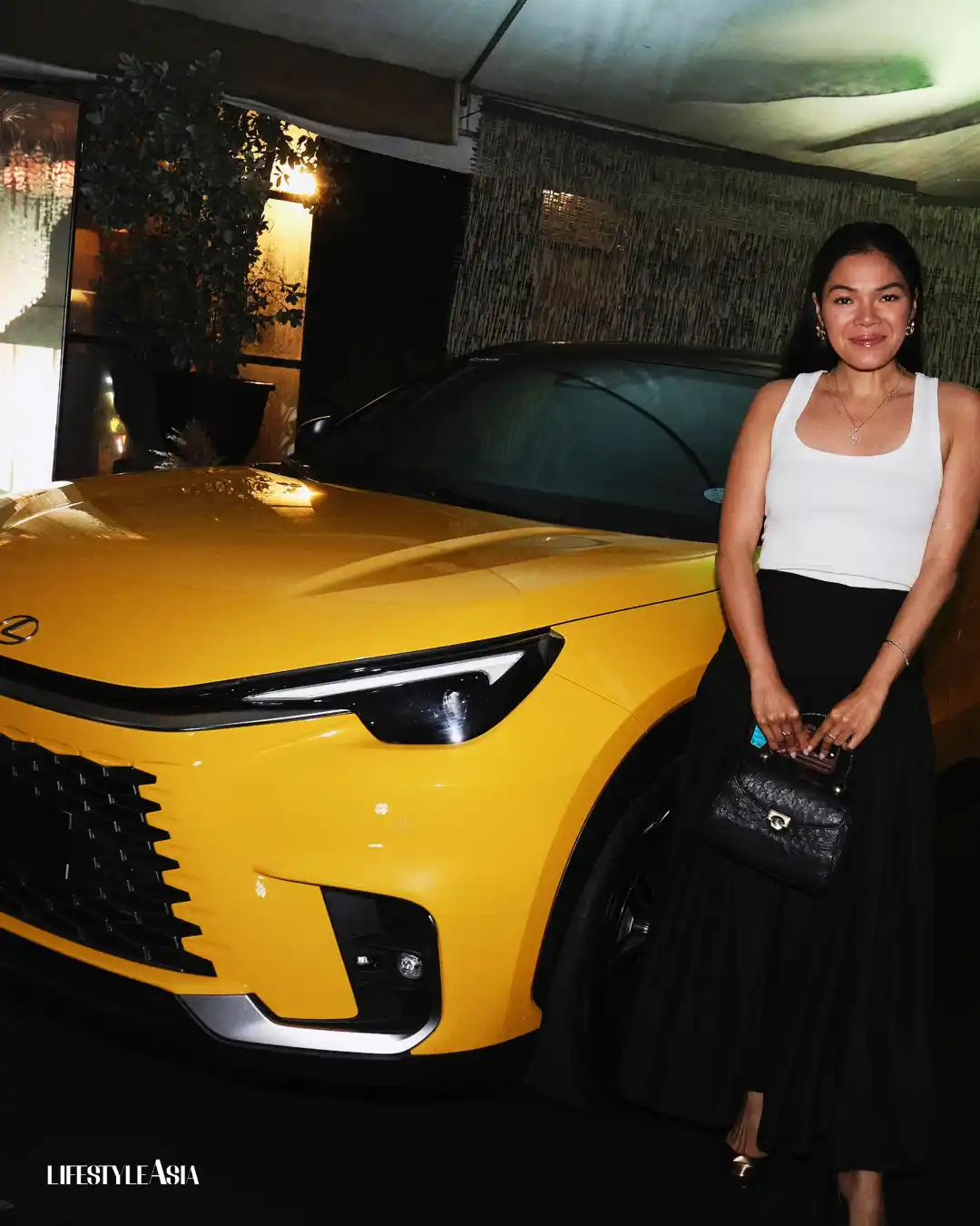 Guests posing with the Lexus LBX