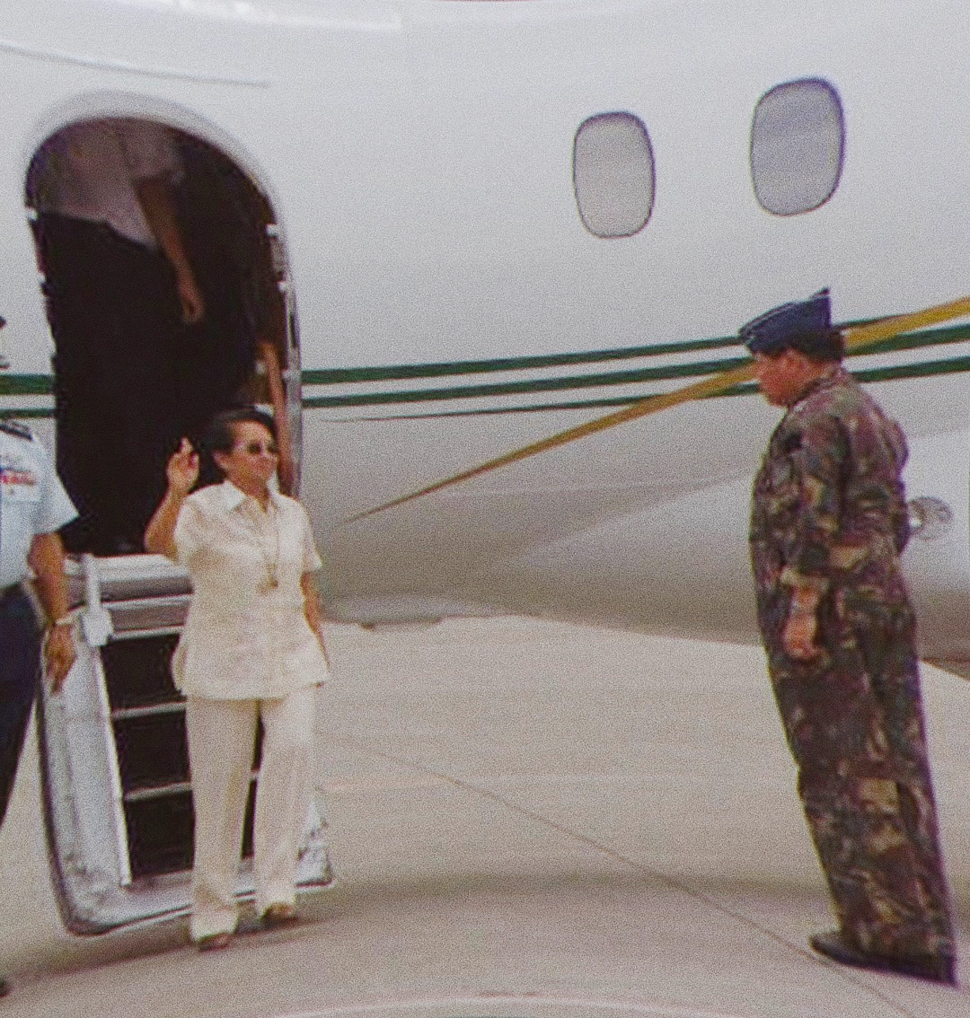 Gloria Macapagal seen wearing a barong as she arrives in Iloilo to preside over a joint Cabinet-NDCC meeting in 2005