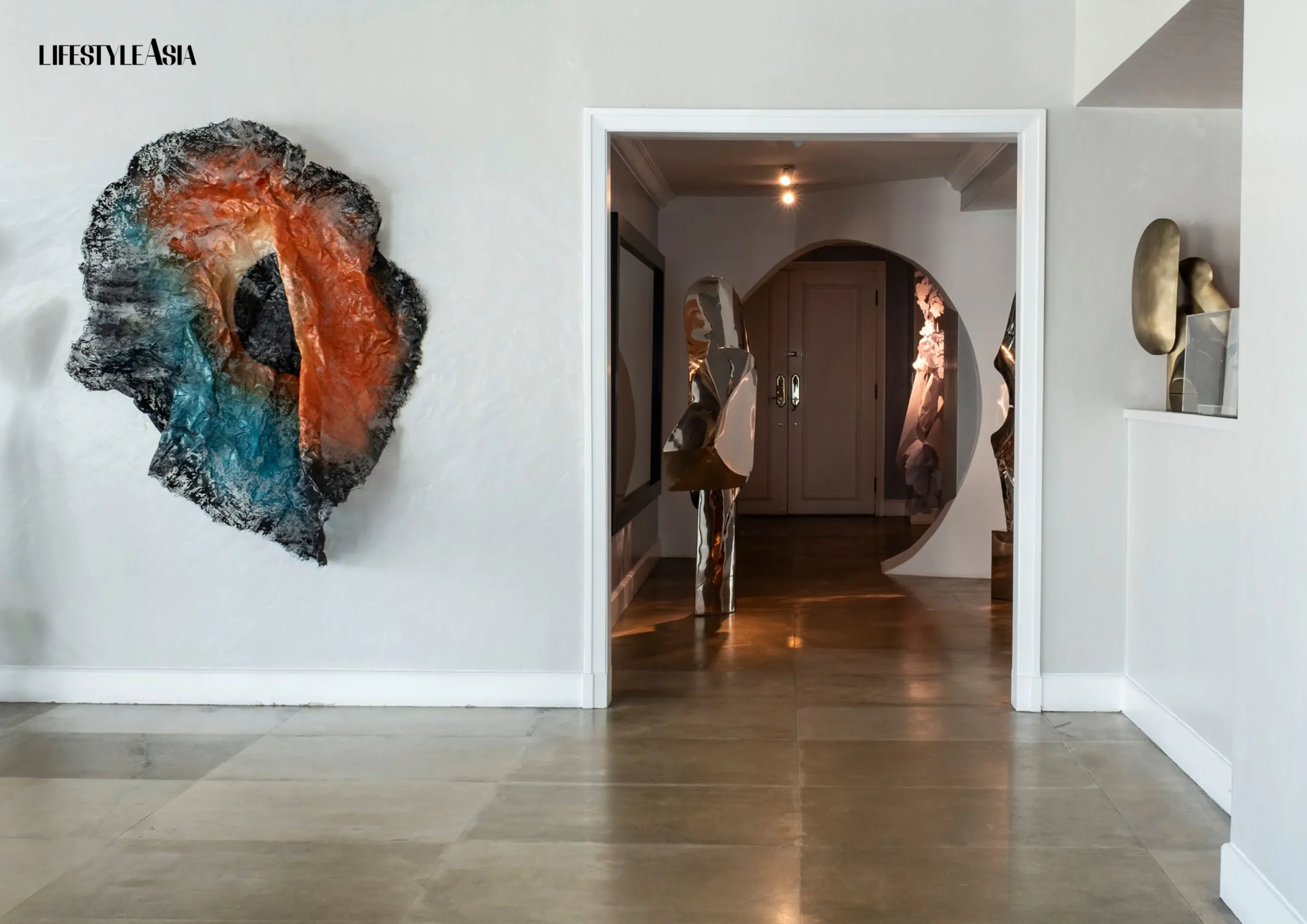 The hallway welcomes guests into the living area, which features other art installations of the couple