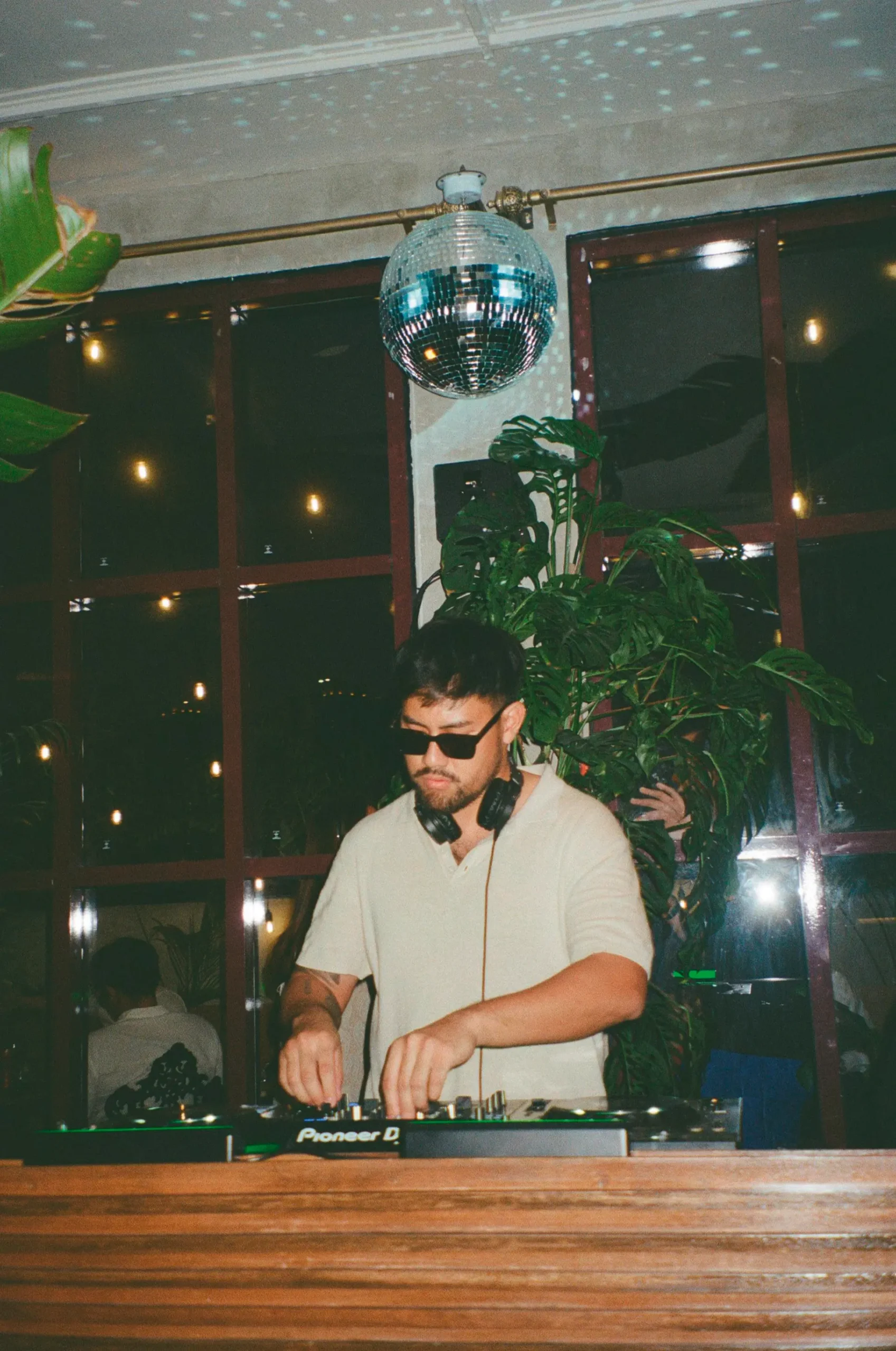 Marco Baluyut behind the DJ booth at his bars