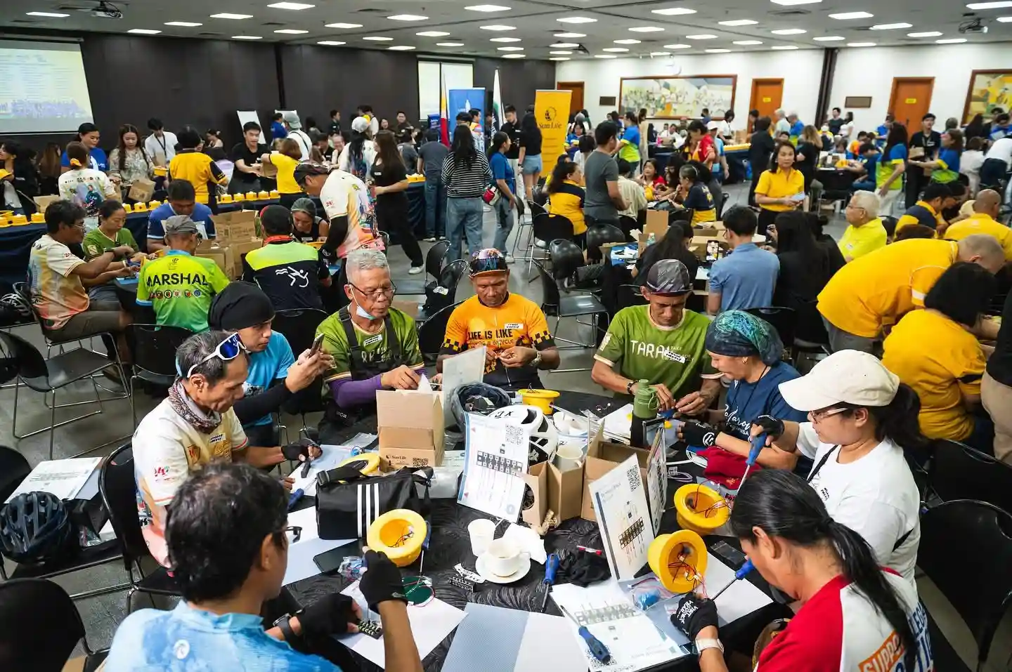 Various community volunteers assembling the solar lamps by hand for the Liter of Light Installation/Photo by Derrick Lim