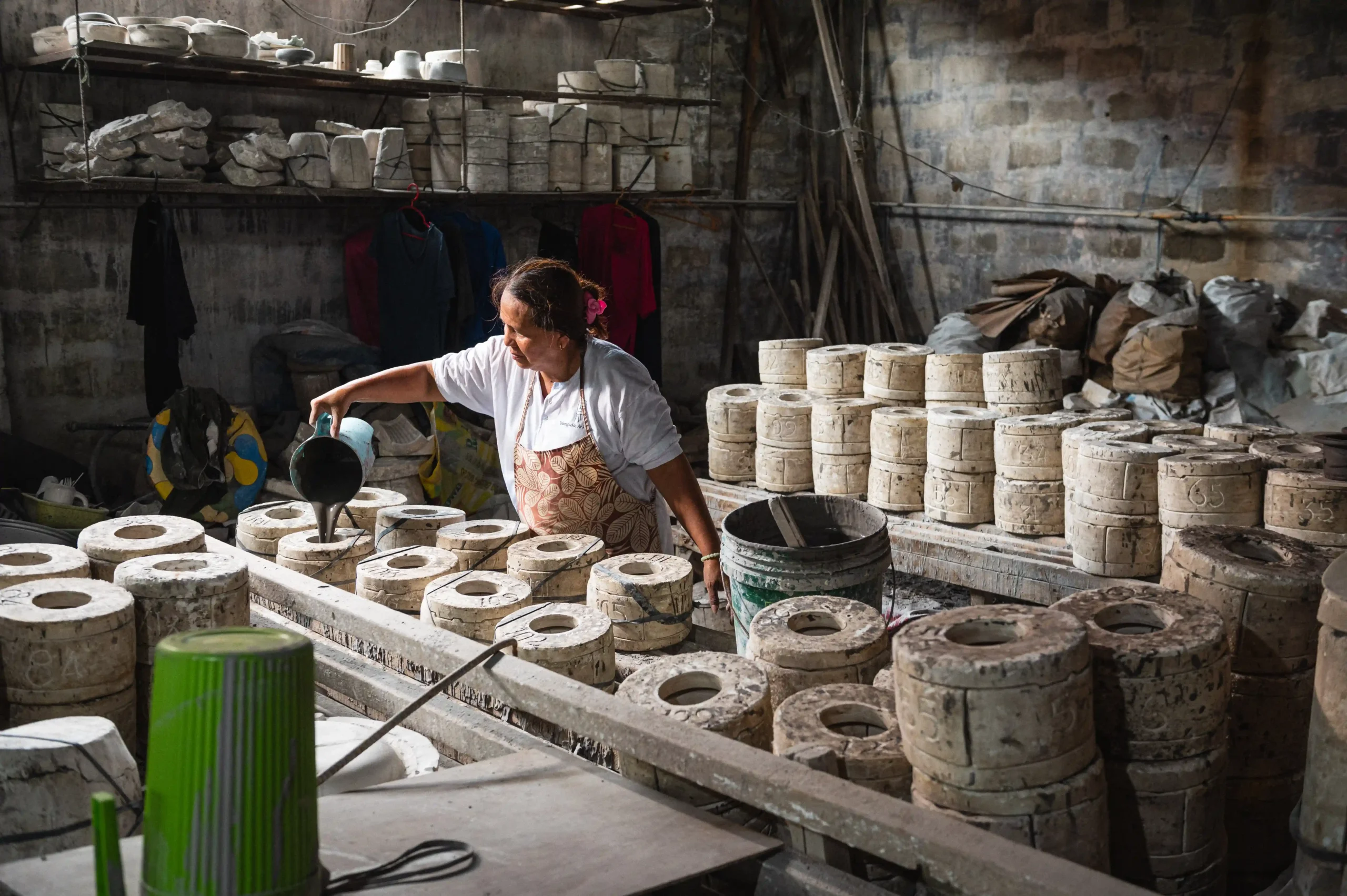 Pouring clay into handcrafted molds during production/Photo by Derrick Lim