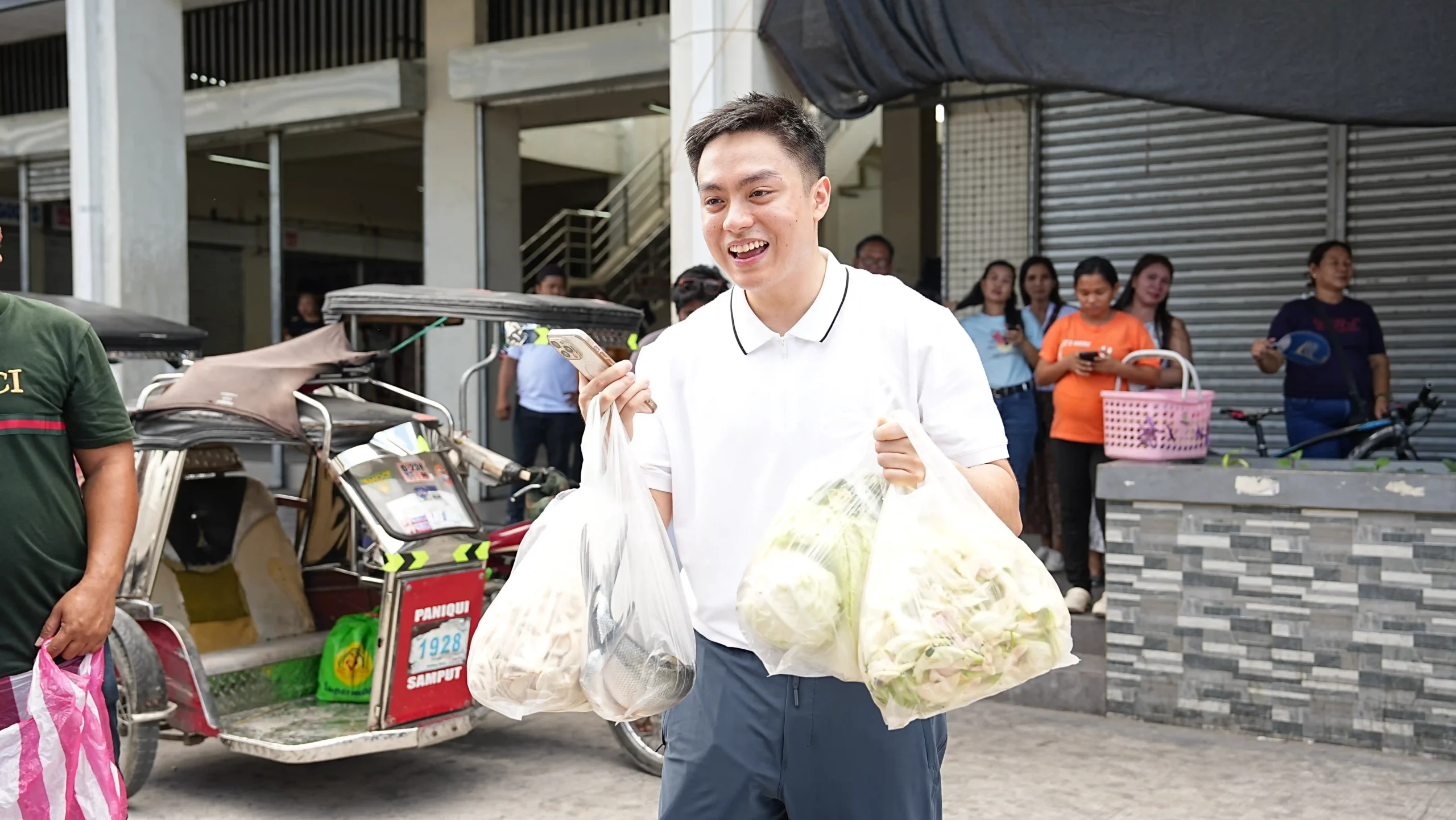 Jaime Cojuangco picks up fresh produce at a local market in Tarlac