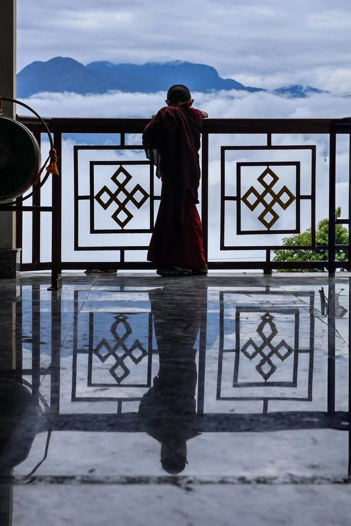 A young monastic student looks to the sky, Sikkim, India