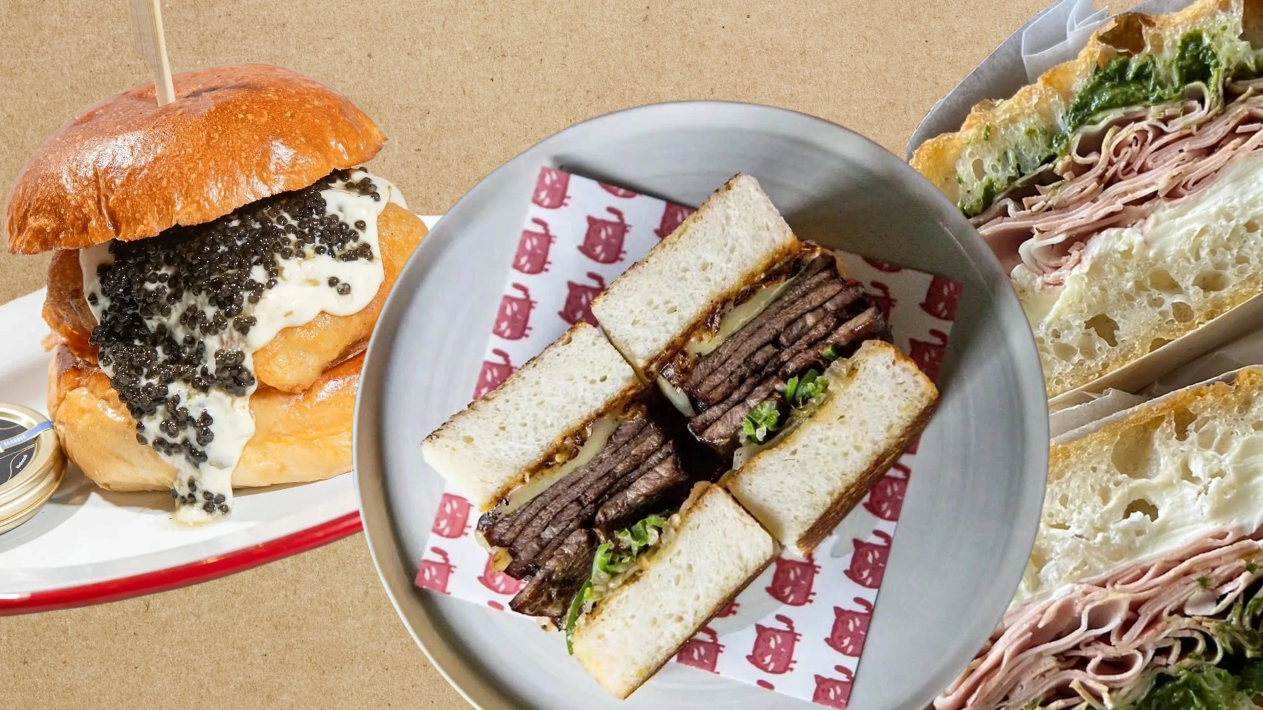 Burger with cream sauce topped by black caviar beside a plate of stacked club sandwiches on a round tray and a spread of crusty bread nearby.