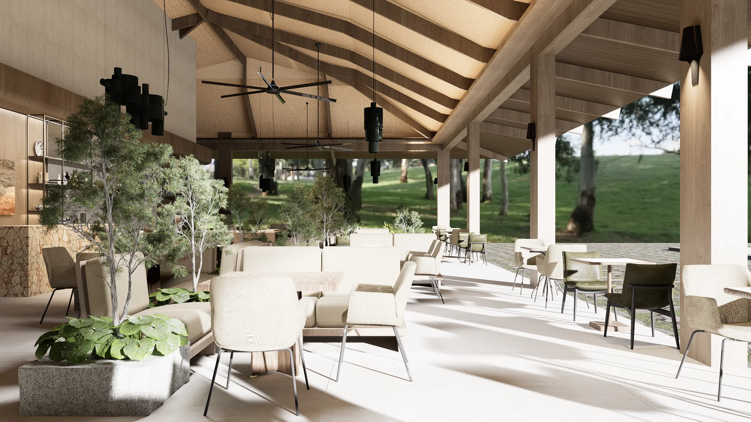 Open-air lounge with beige upholstered chairs, wooden beams, and ceiling fans under a thatched roof; greenery and outdoor landscape visible outside.