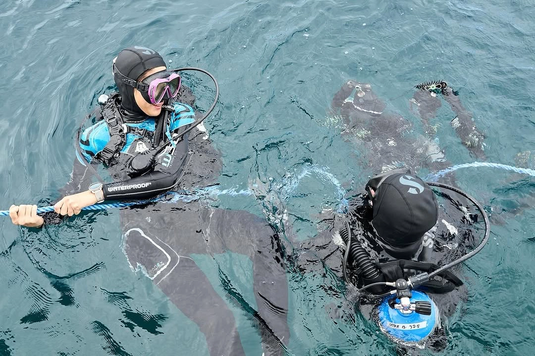 Andie Remulla in the water with her mentor, Mike Bartick