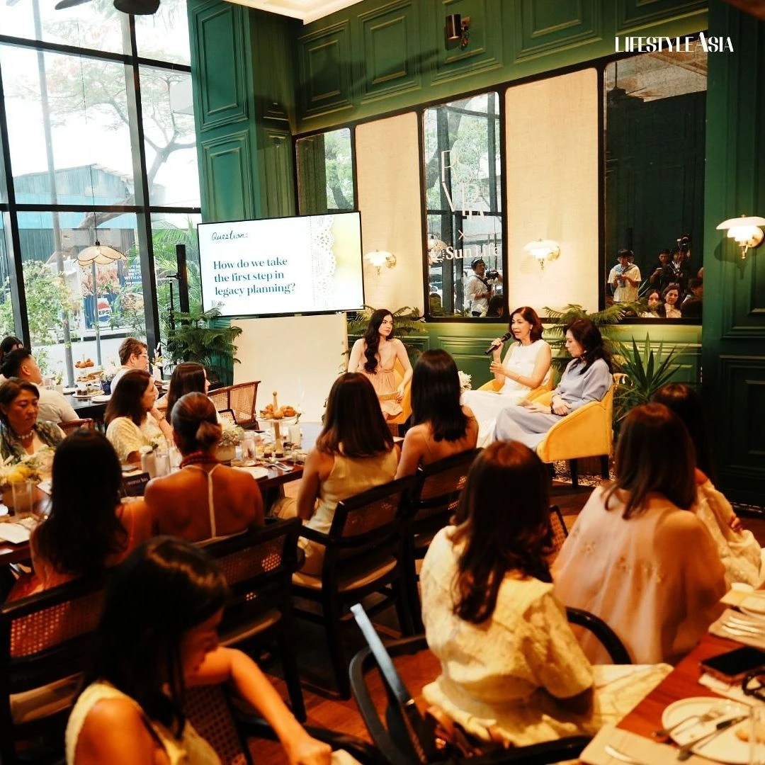 Panel discussion at a dining venue with three women on stage and a screen showing a question.