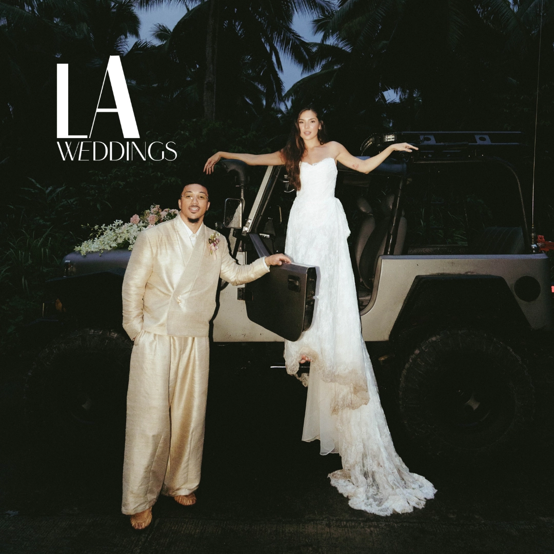 Bride in white lace dress and groom in beige suit step from a Jeep at night; tropical backdrop and LA Weddings logo.