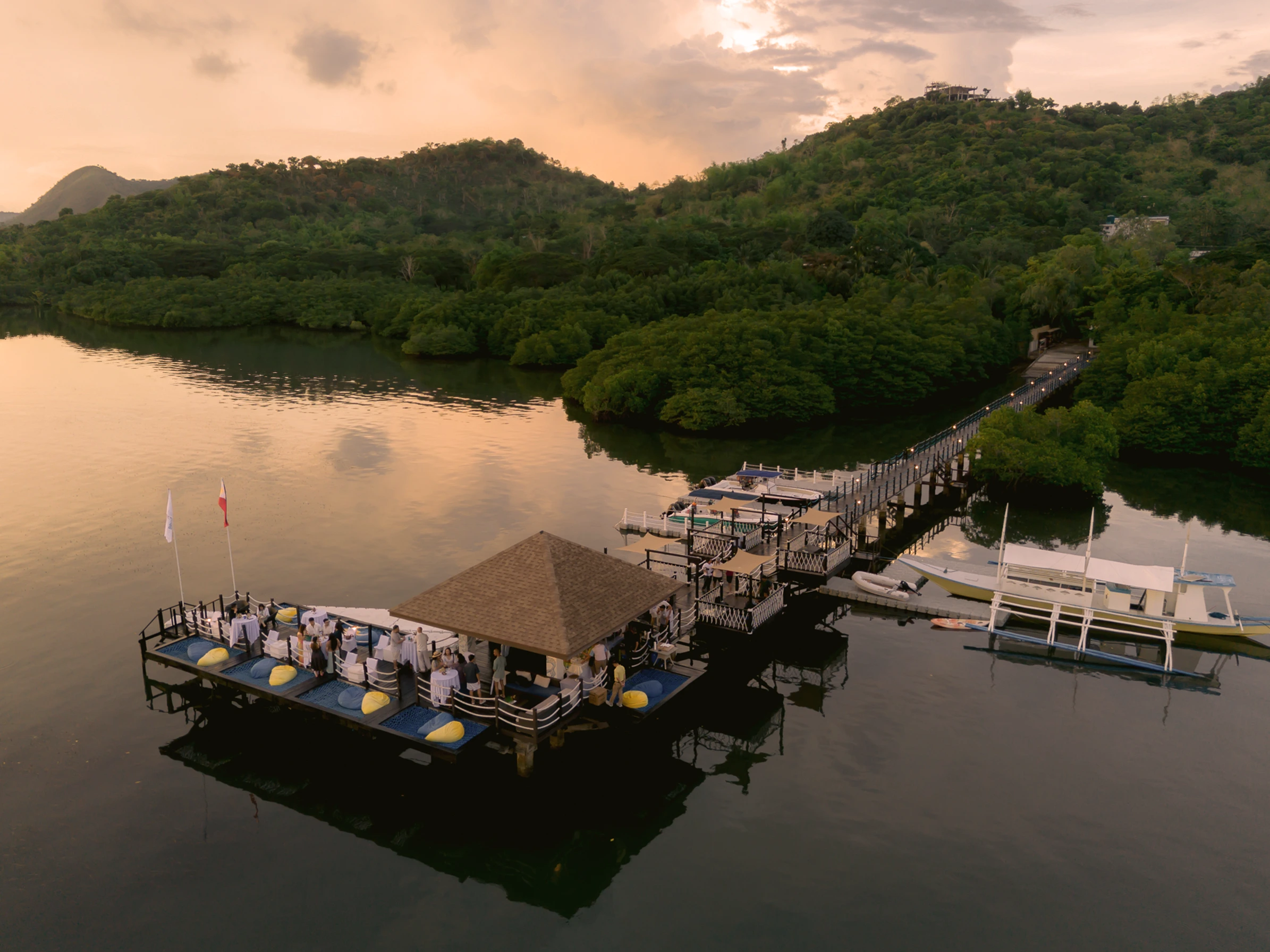 An aerial view of Sirena Pier Bar, which offers an inimitable sunset view surrounded by reflective waters and lush mangrove trees