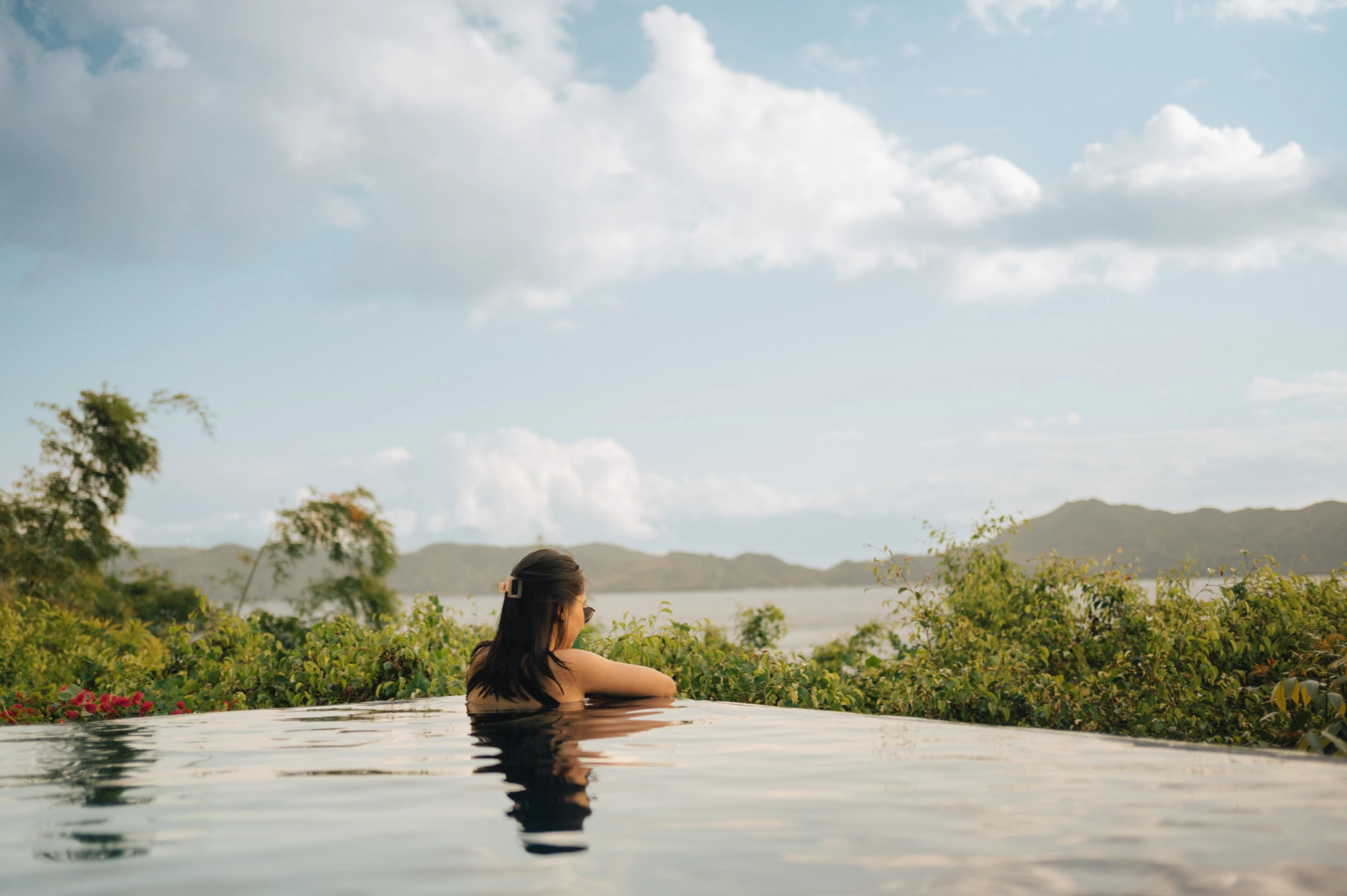 A guest enjoys the picturesque views of Anilao from Vivere Azure's infinity pool
