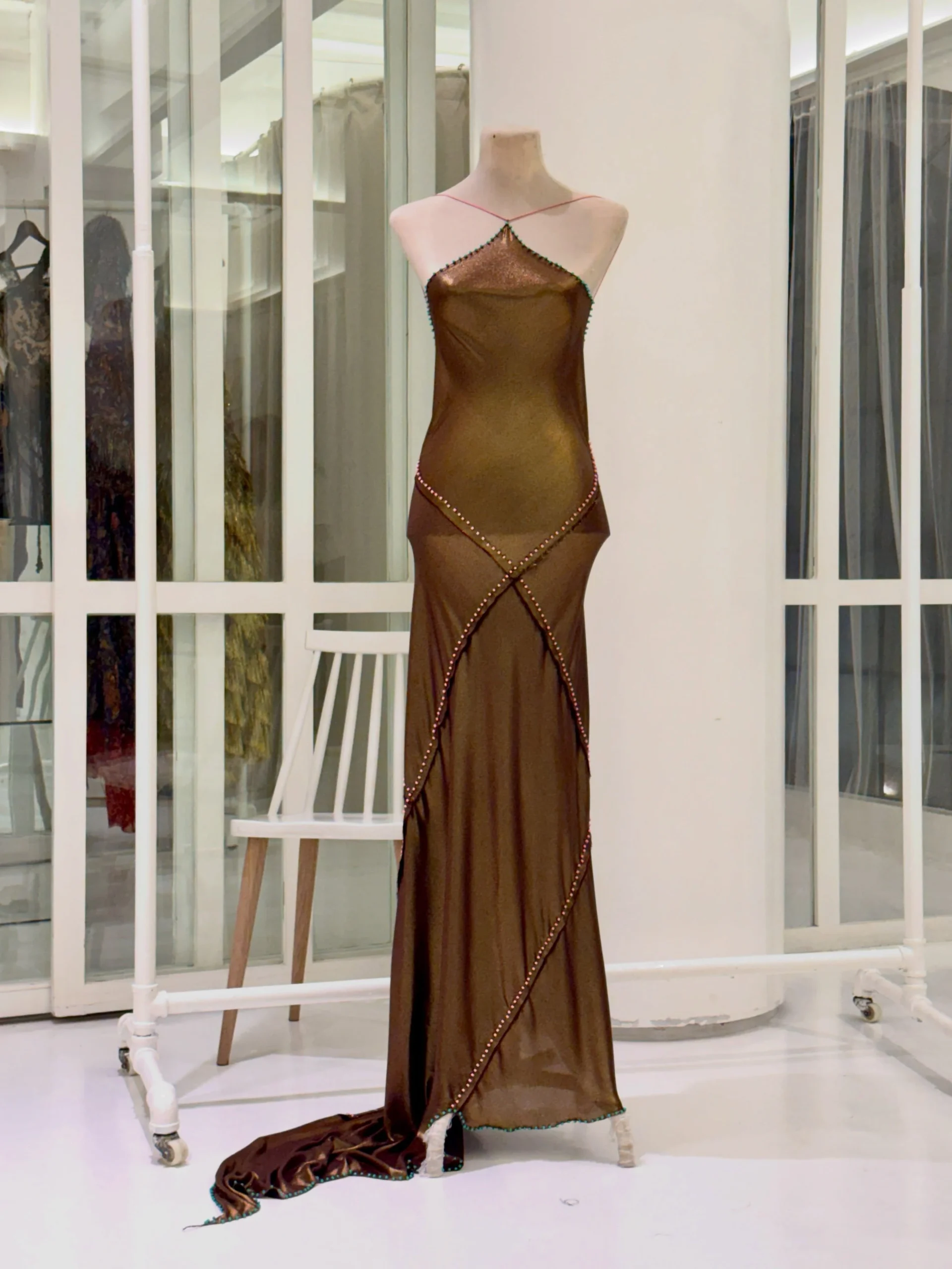 Gold lamé halter paneled bias slip dress by Jude Macasinag