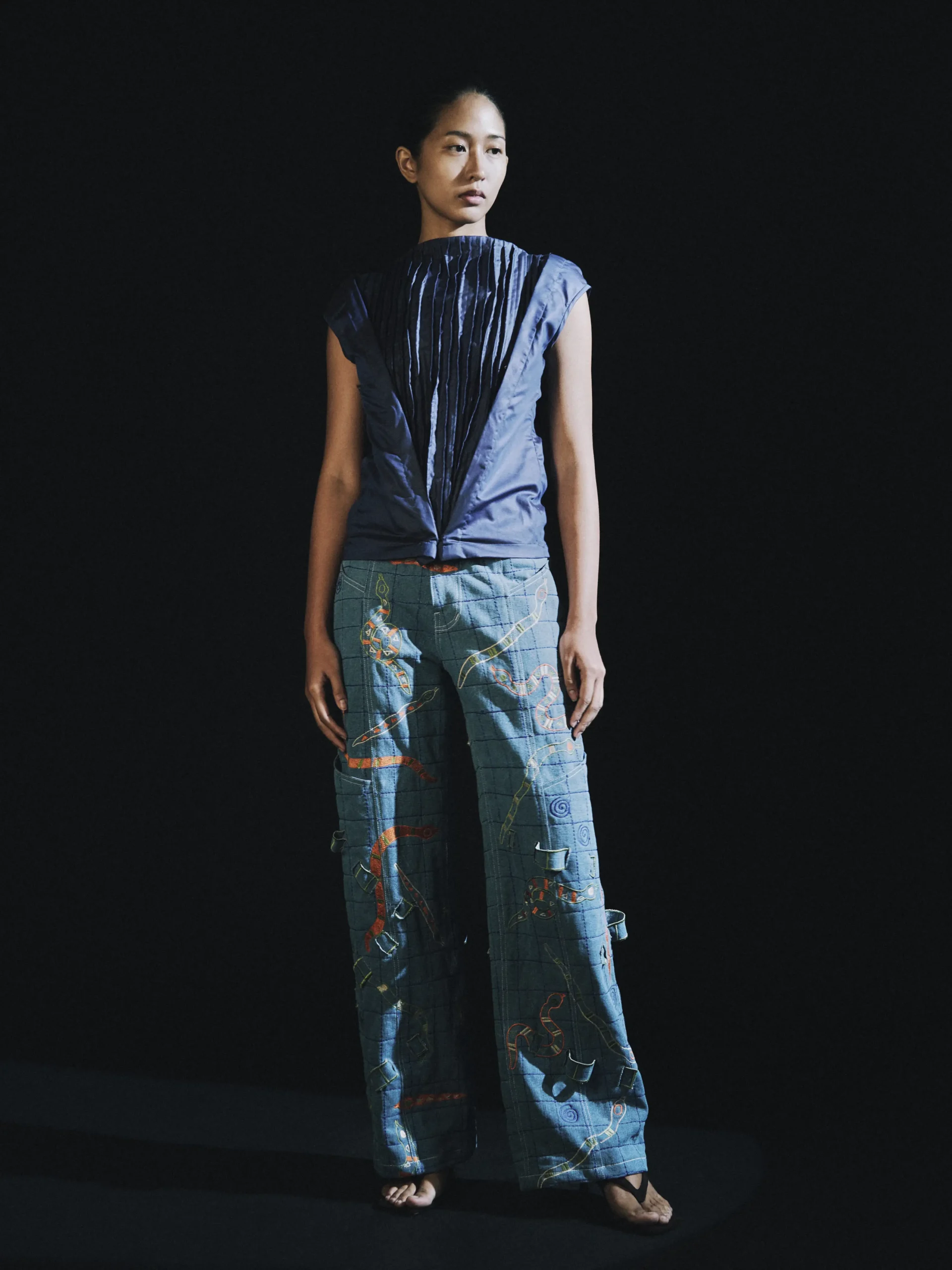 Pleated top and denim trousers by Kelvin Morales