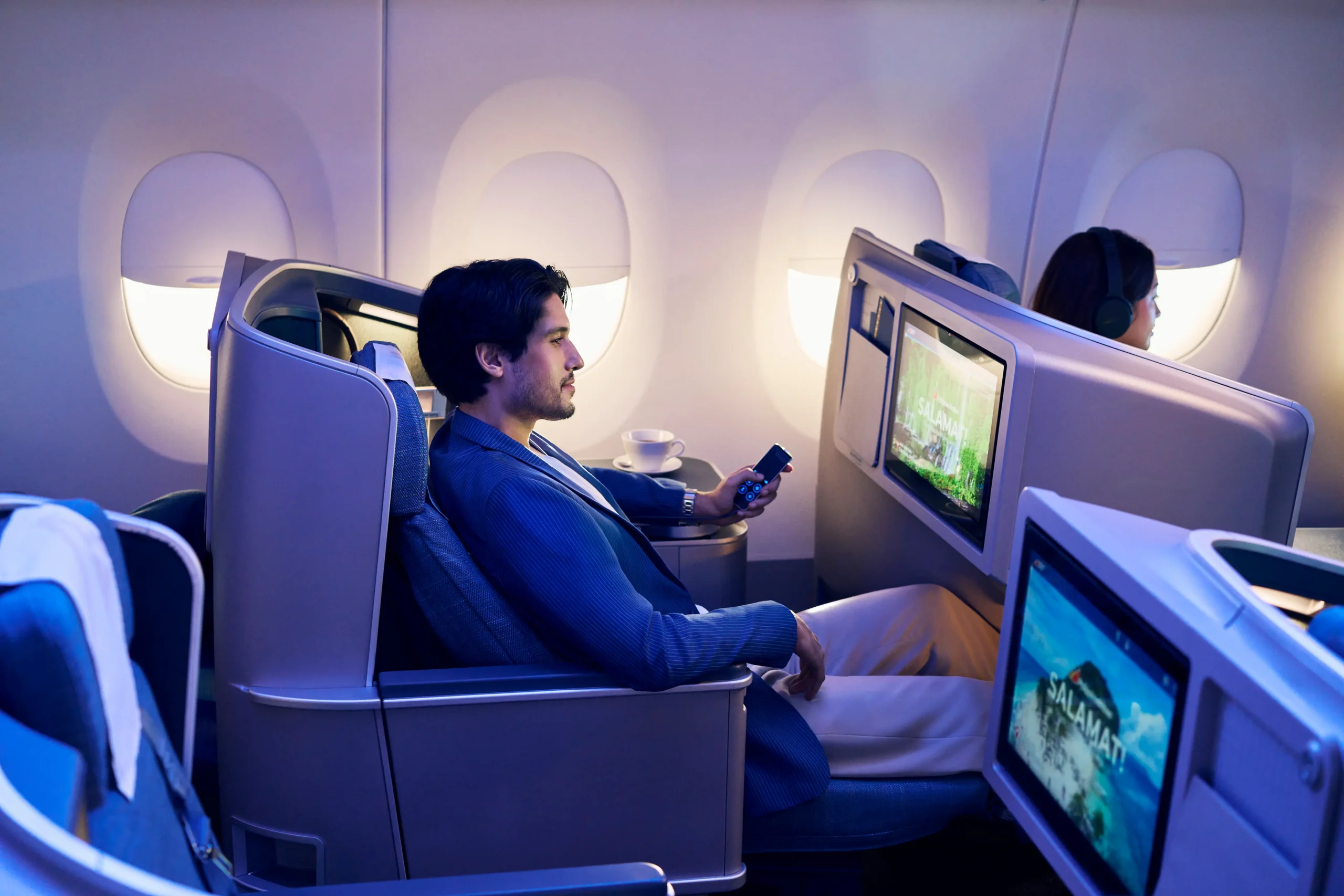 man watching screen PAL business class
