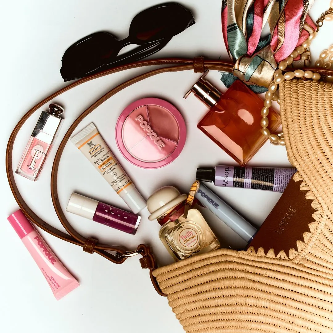 travel kit Travel-Sized Beauty Items To Take On Your Next Trip Kiss Me Multi-Peptide Lip Balm by POPIQUE; Dior Addict Lip Glow Oil by DIOR; Hermèsistible in Pourpre Camarine by HERMÈS; Better Screen UV Serum by KIEHL’S; All-over Multiuse Cream Palette in Malibu Melon by POPIQUE; Twilly d’Hermès by HERMÈS; Swing Bag in Raﬃa and Calfskin by LOEWE; All-over Multiuse Cream Palette in Malibu Melon by POPIQUE; Idole Fragrances by LANCÔME; Eleos Aromatique Hand Balm by AESOP; Let Them Grow Brow and Lash Serum by POPIQUE.