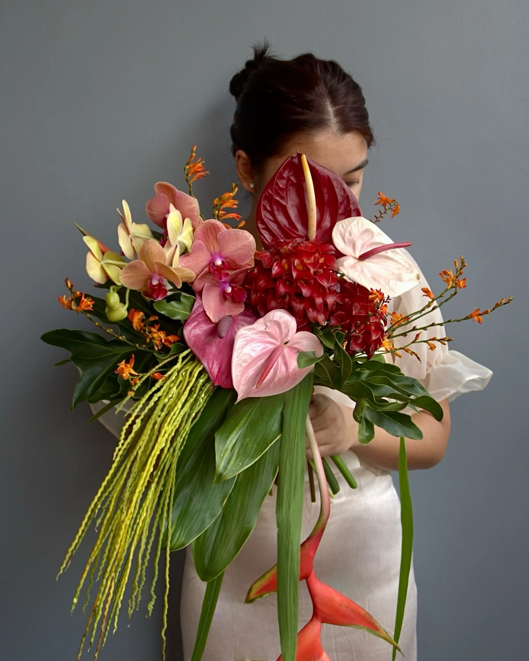 A bridal bouquet by Florio, featuring ginger flowers and orchids floral design studio