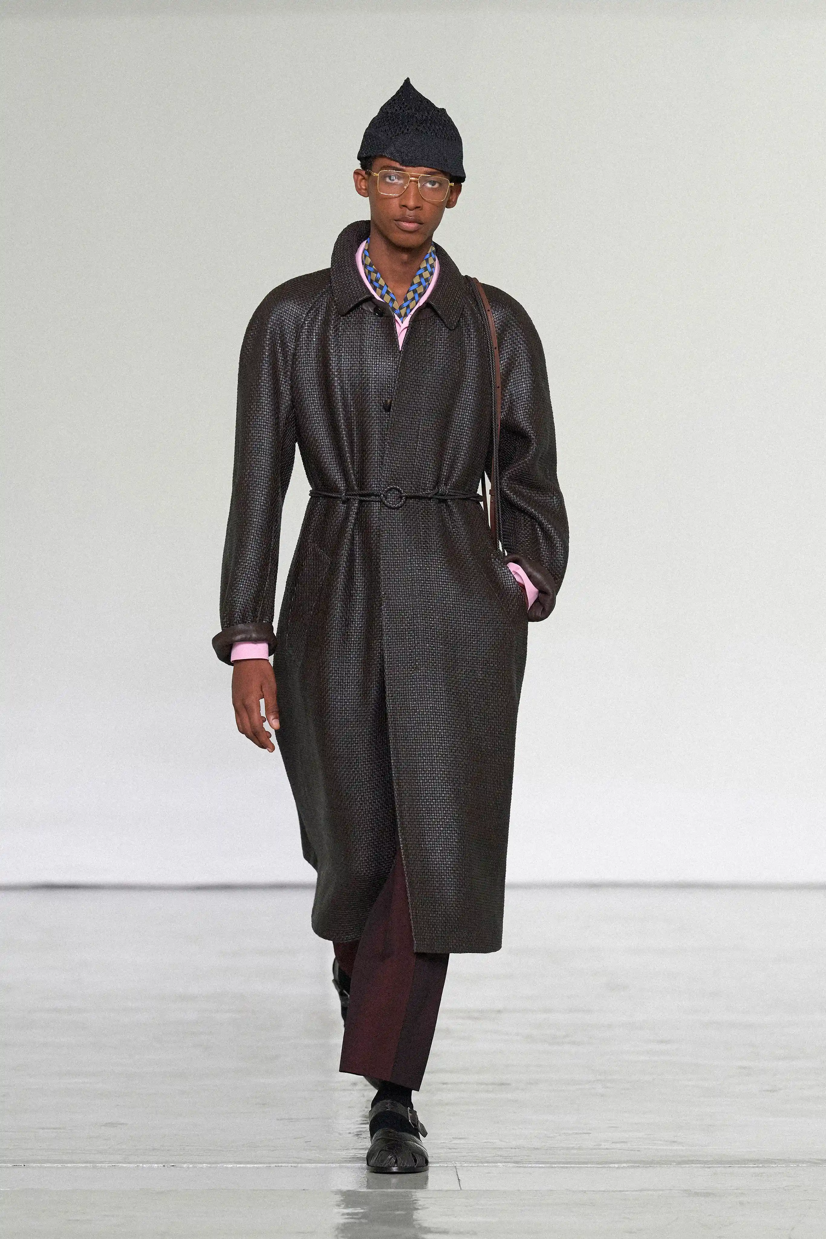 A flash of pink under a leather longcoat seen on the Bottega Veneta Spring/Summer 2027 runway